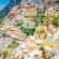 A hilly, seaside town on the Amalfi Coast, with a busy beach and bustling harbor